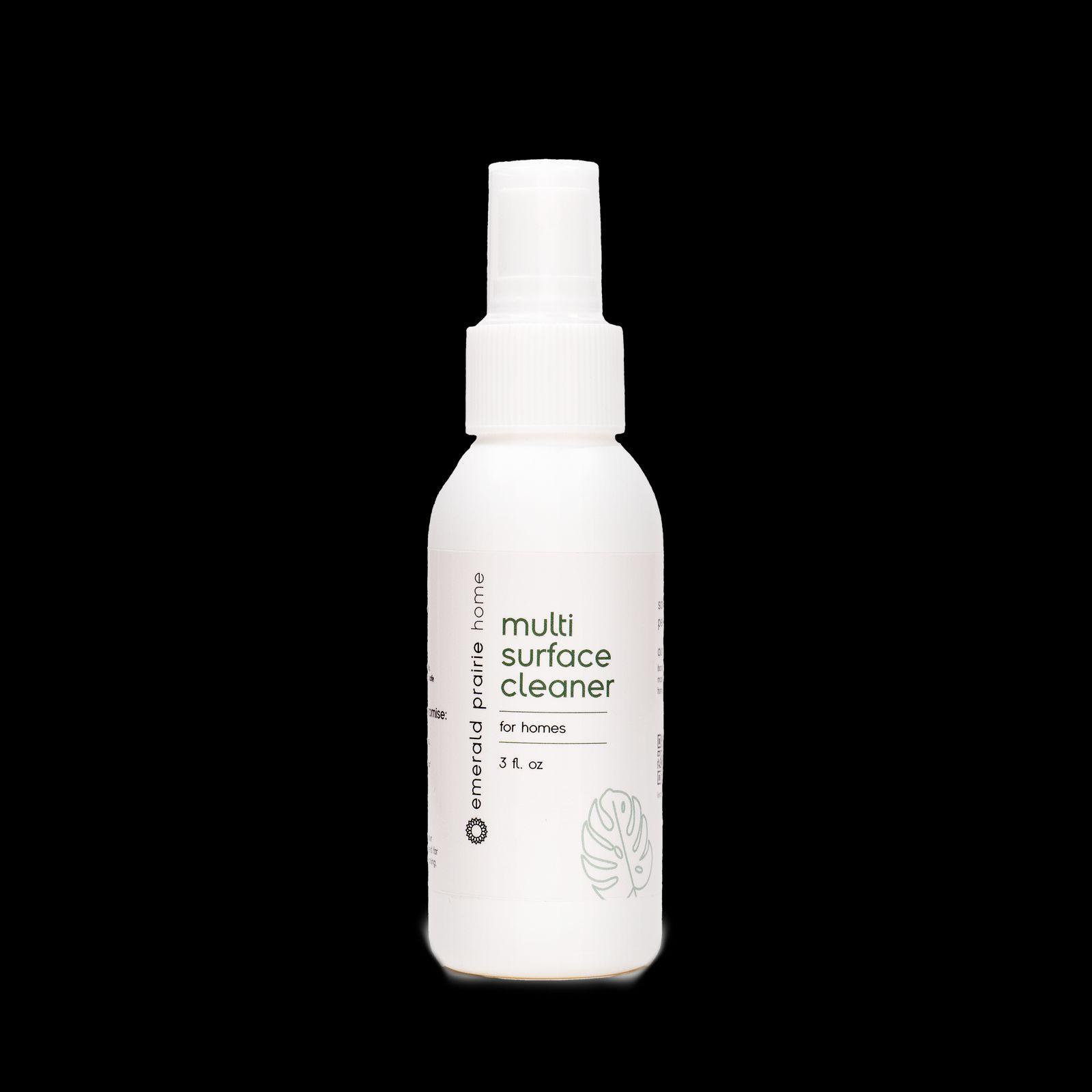 a bottle of multi surface cleaner on a black background