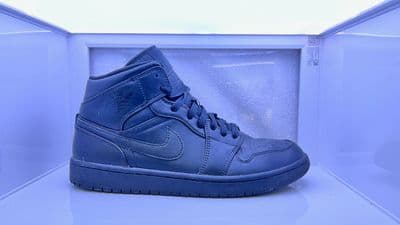 a pair of blue sneakers sitting on top of a shelf