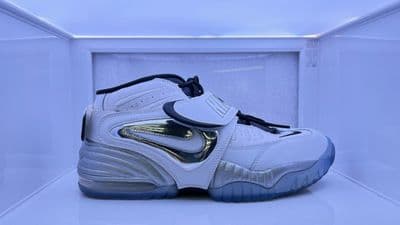 a pair of white and blue sneakers in a display case