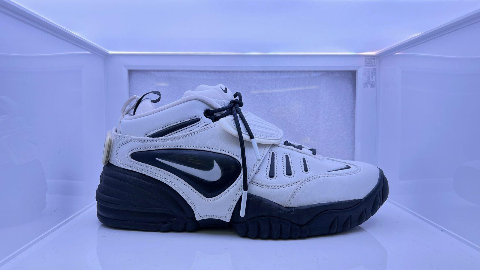 a pair of white and black sneakers on display