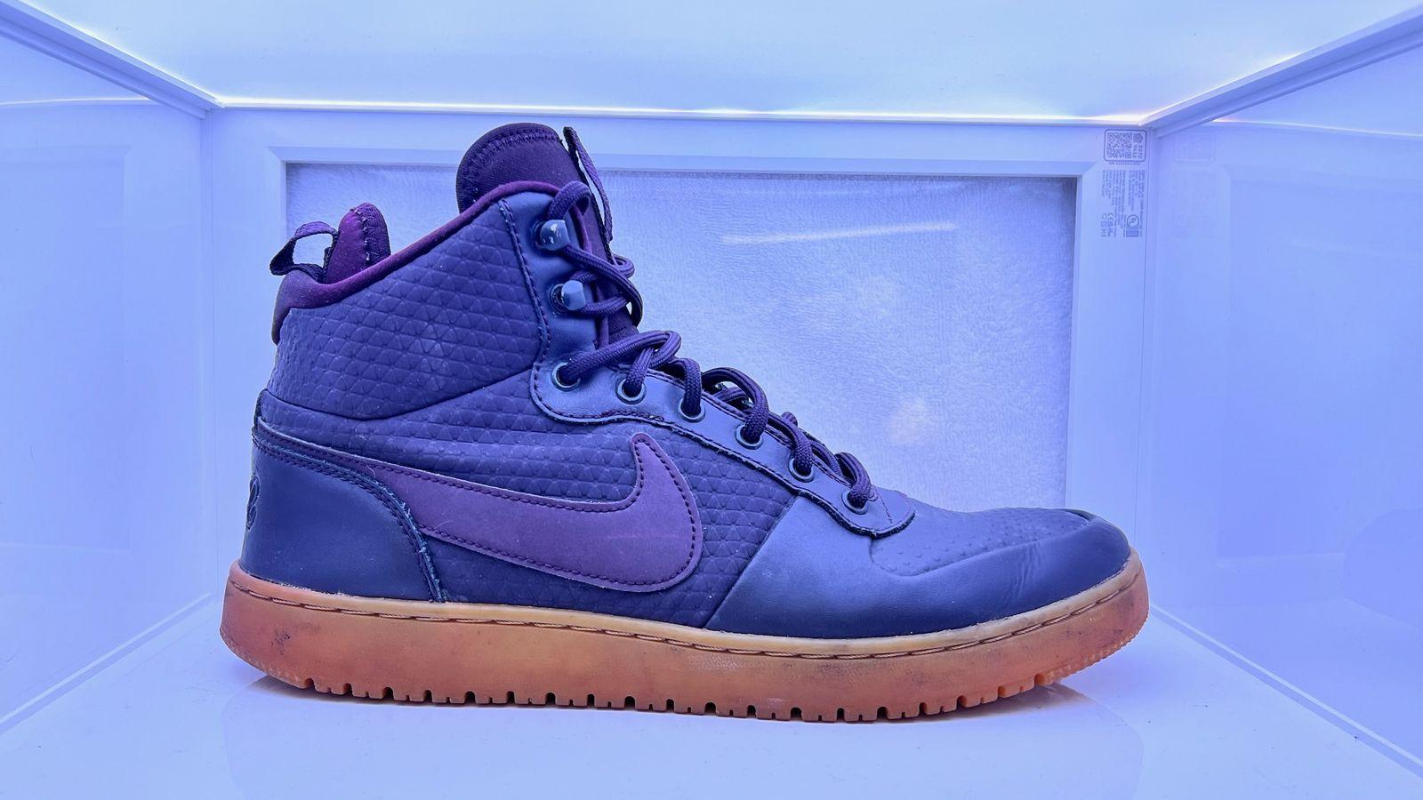 a pair of blue and purple sneakers sitting on top of a counter