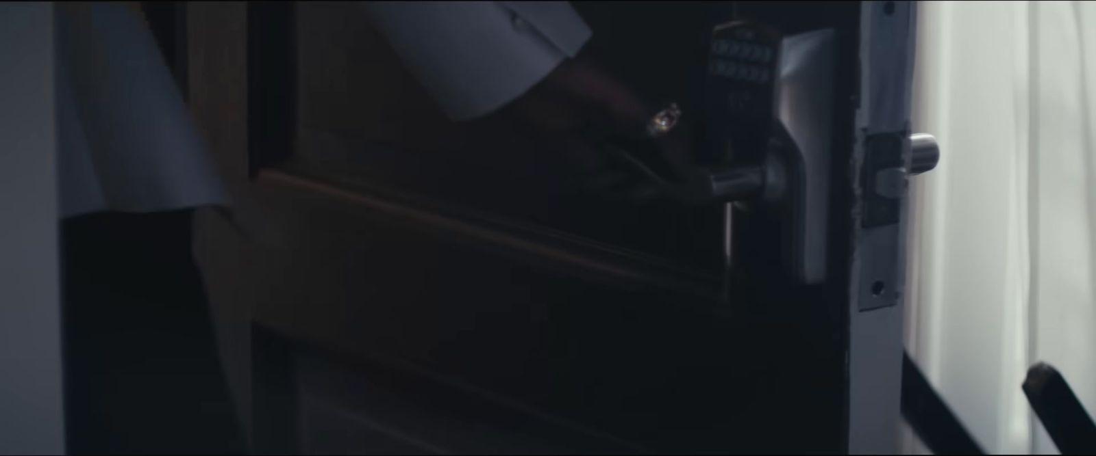 a person opening a door with their hand