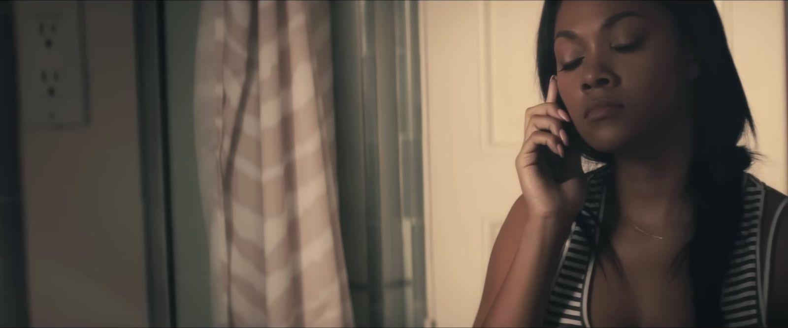 a woman talking on a cell phone in a room