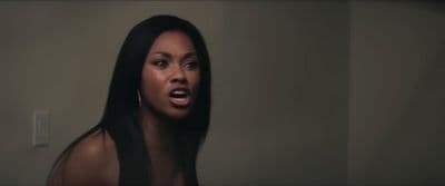 a woman with long black hair is making a face