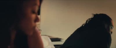 a woman with glasses looking at a computer screen