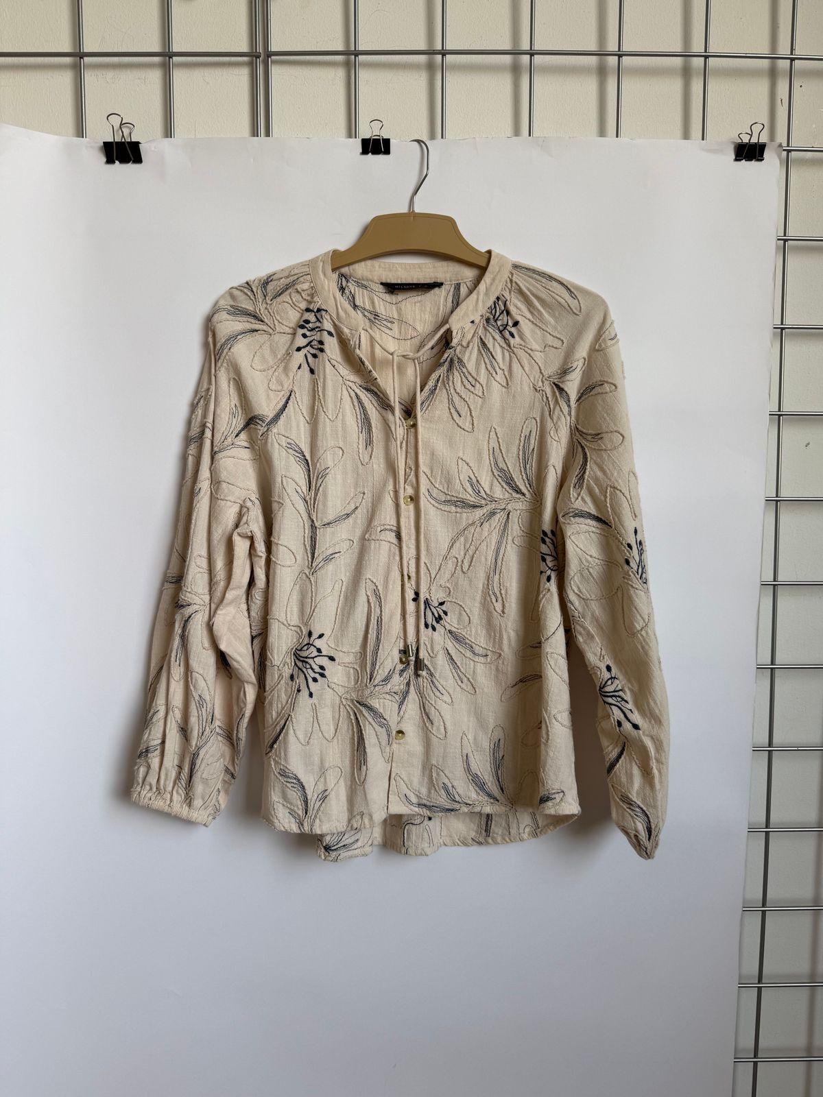 a shirt hanging on a wall with a hanger