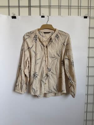 a shirt hanging on a wall with a hanger