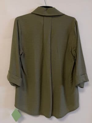 a green jacket hanging on a wall