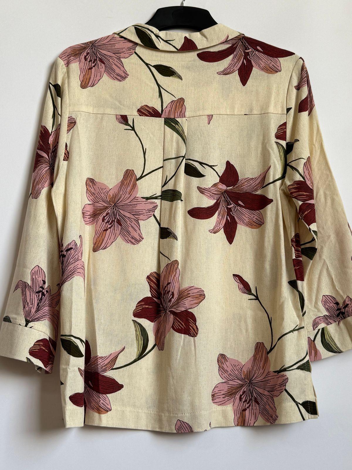 a white shirt with pink flowers on it