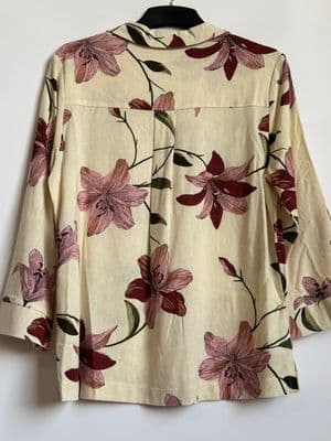 a white shirt with pink flowers on it
