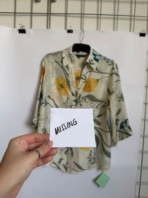 a person holding a piece of paper that says missing