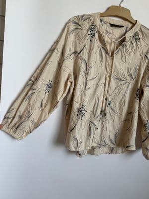 a shirt hanging on a wall with a hanger