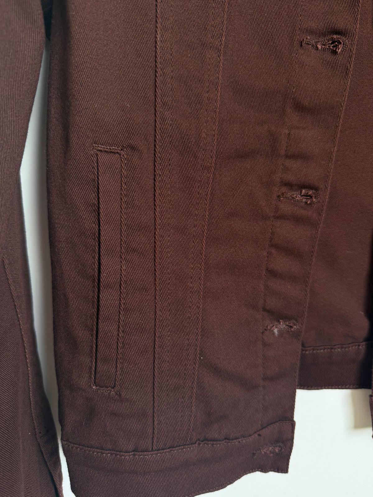 a close up of a brown jacket on a white background
