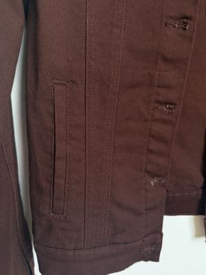 a close up of a brown jacket on a white background