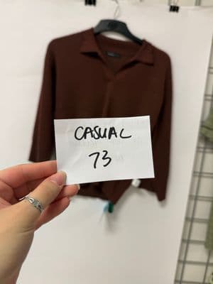 a person holding a piece of paper in front of a shirt