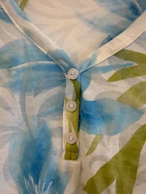 a close up of a shirt with a flower pattern