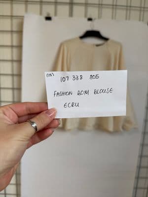 a person holding a piece of paper with a label on it