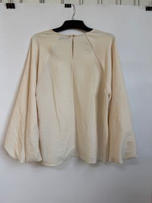 a white shirt hanging on a white wall