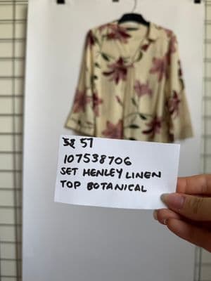 a person holding a piece of paper with a shirt on it
