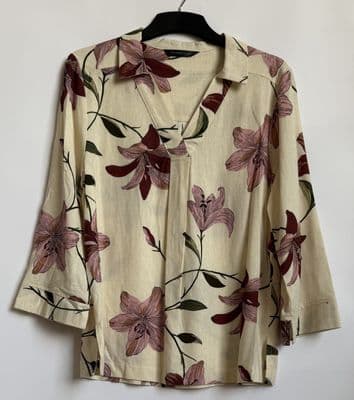 a shirt with a flower pattern hanging on a hanger