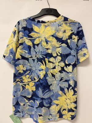 a blue and yellow floral shirt hanging on a hanger