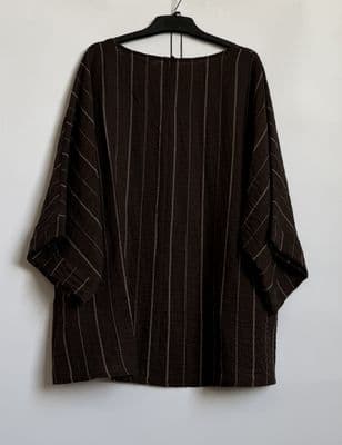 a black and white striped shirt hanging on a wall