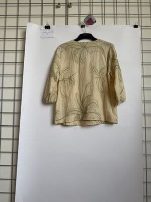 a shirt hanging on a wall with a hanger