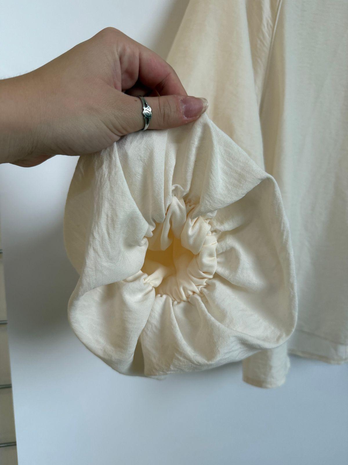 a person holding a white cloth with a flower in it