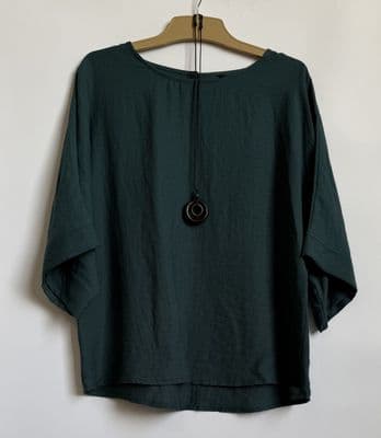 a green top hanging on a hanger