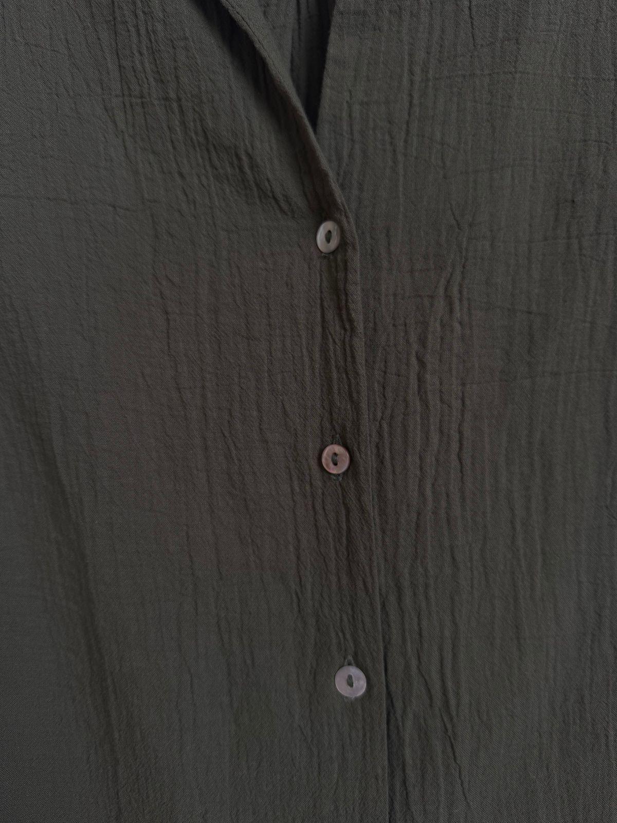 a close up of a shirt with buttons on it