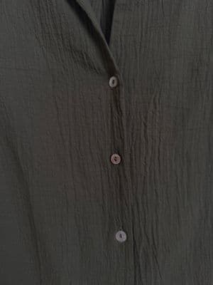 a close up of a shirt with buttons on it
