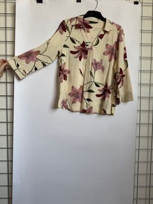 a woman's blouse hanging on a clothes rack