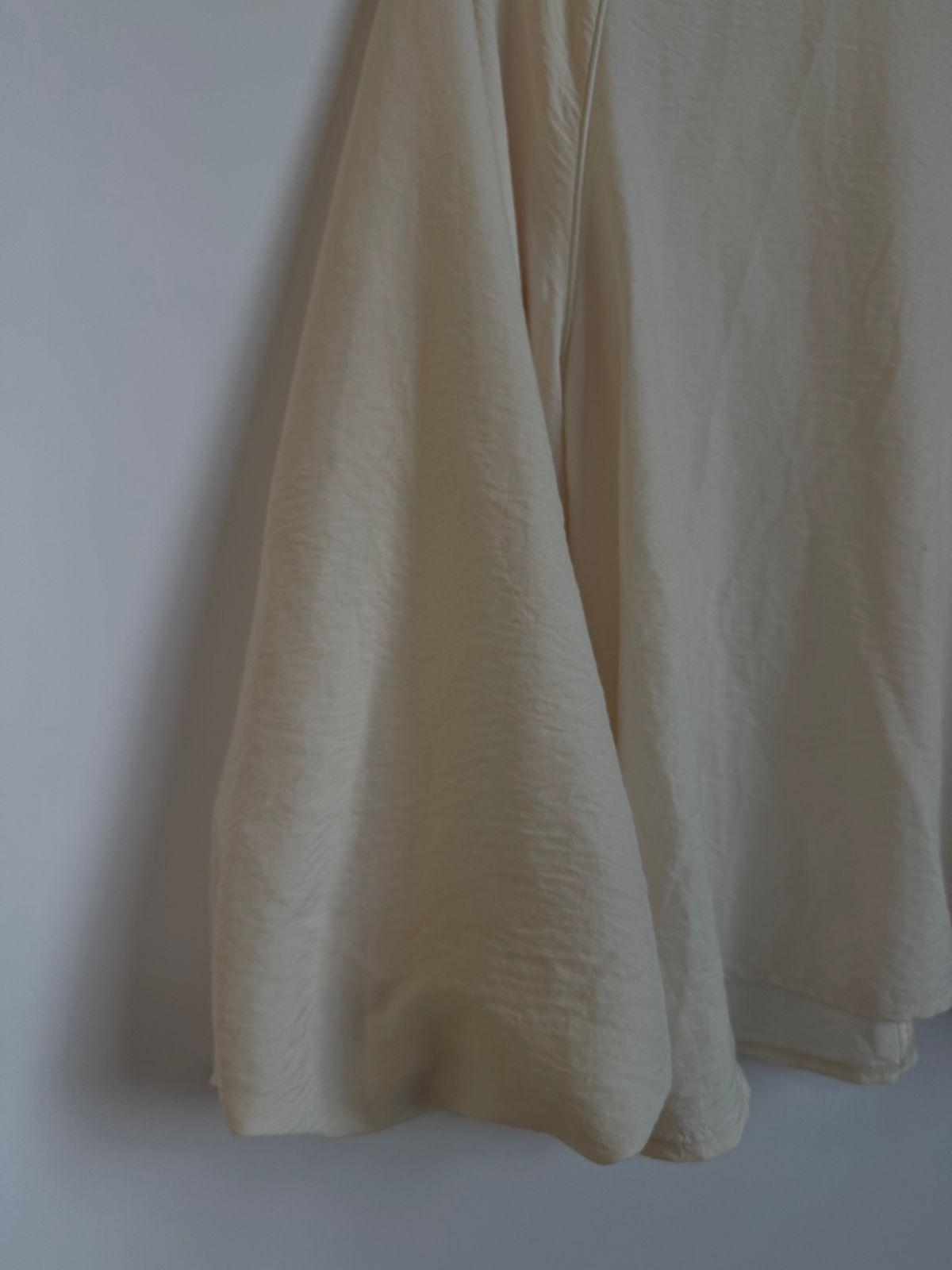a pair of white pants hanging on a wall