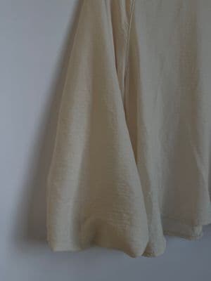 a pair of white pants hanging on a wall