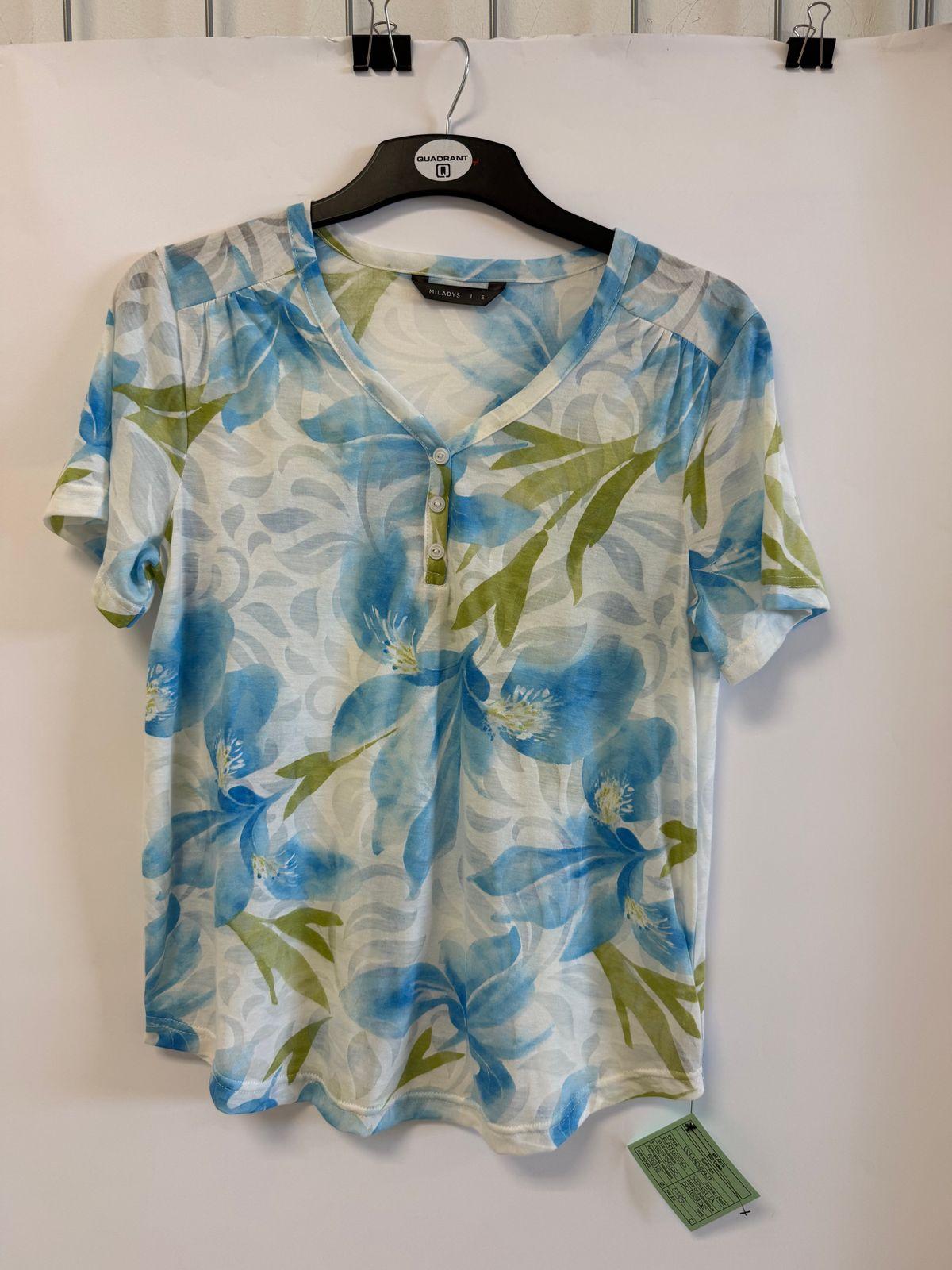 a blue and green shirt hanging on a wall
