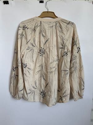 a shirt hanging on a wall with a hanger