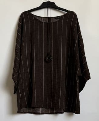 a shirt hanging on a hanger on a wall