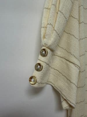 a close up of a sweater with buttons on it
