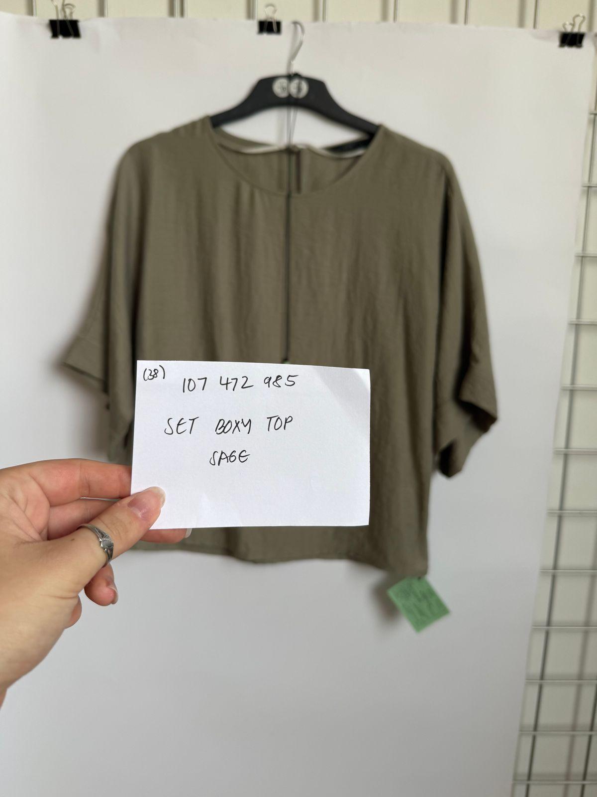 a person holding a piece of paper with a note attached to it