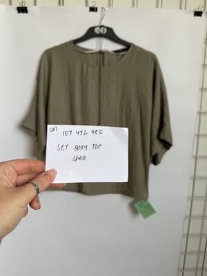 a person holding a piece of paper with a note attached to it