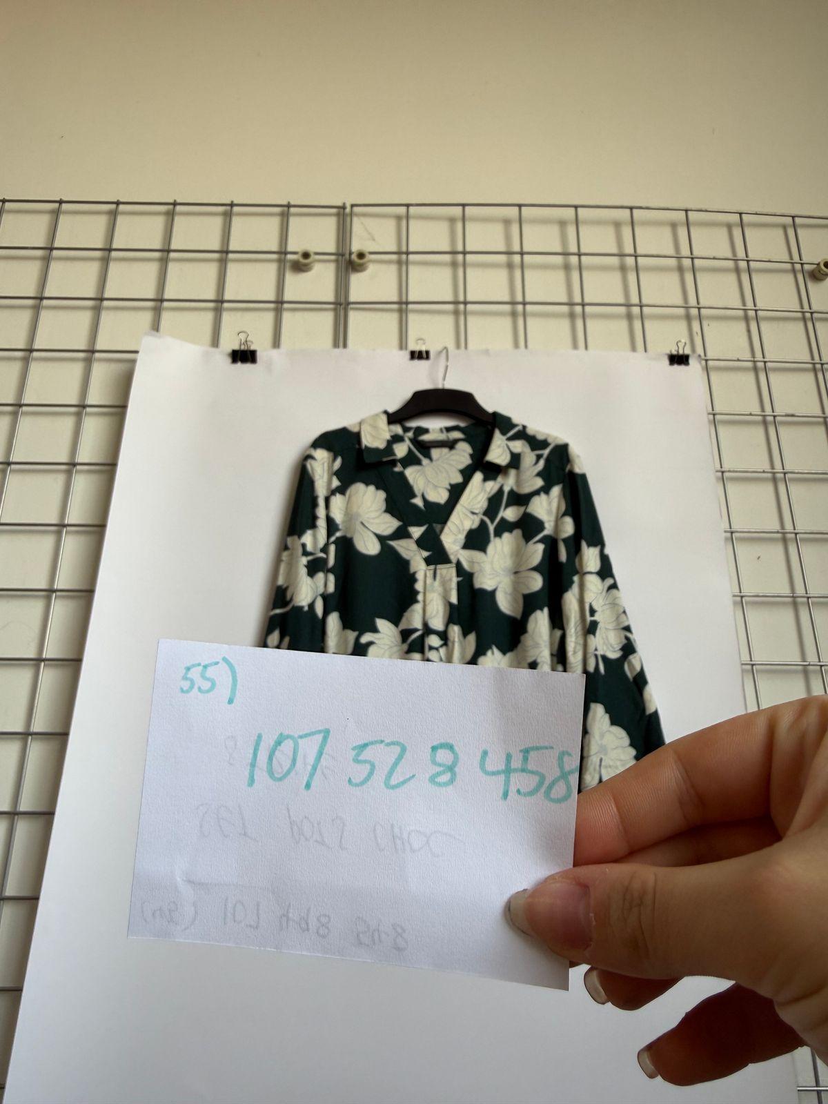 a person holding a piece of paper next to a shirt