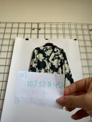 a person holding a piece of paper next to a shirt