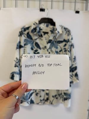 a person holding a piece of paper in front of a shirt