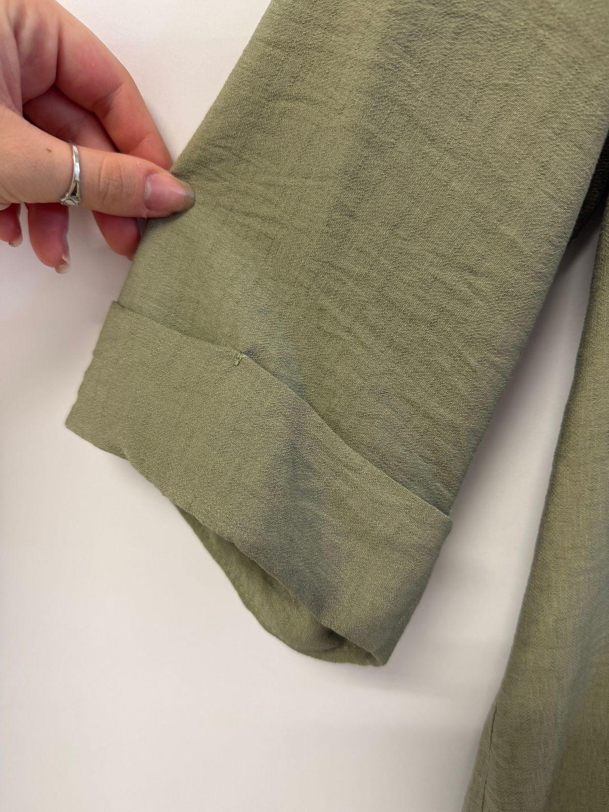 a woman's hand is holding a piece of linen