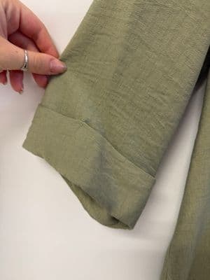 a woman's hand is holding a piece of linen