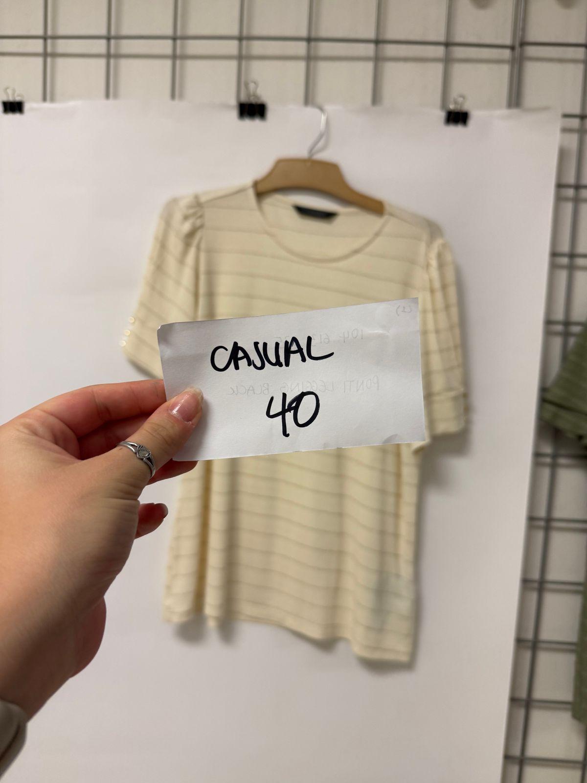 a person holding a piece of paper with a shirt on it