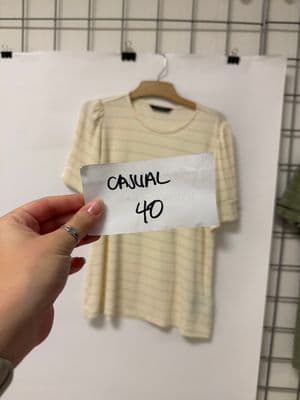 a person holding a piece of paper with a shirt on it