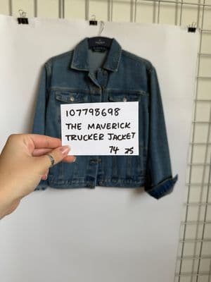 a person holding a piece of paper in front of a jacket