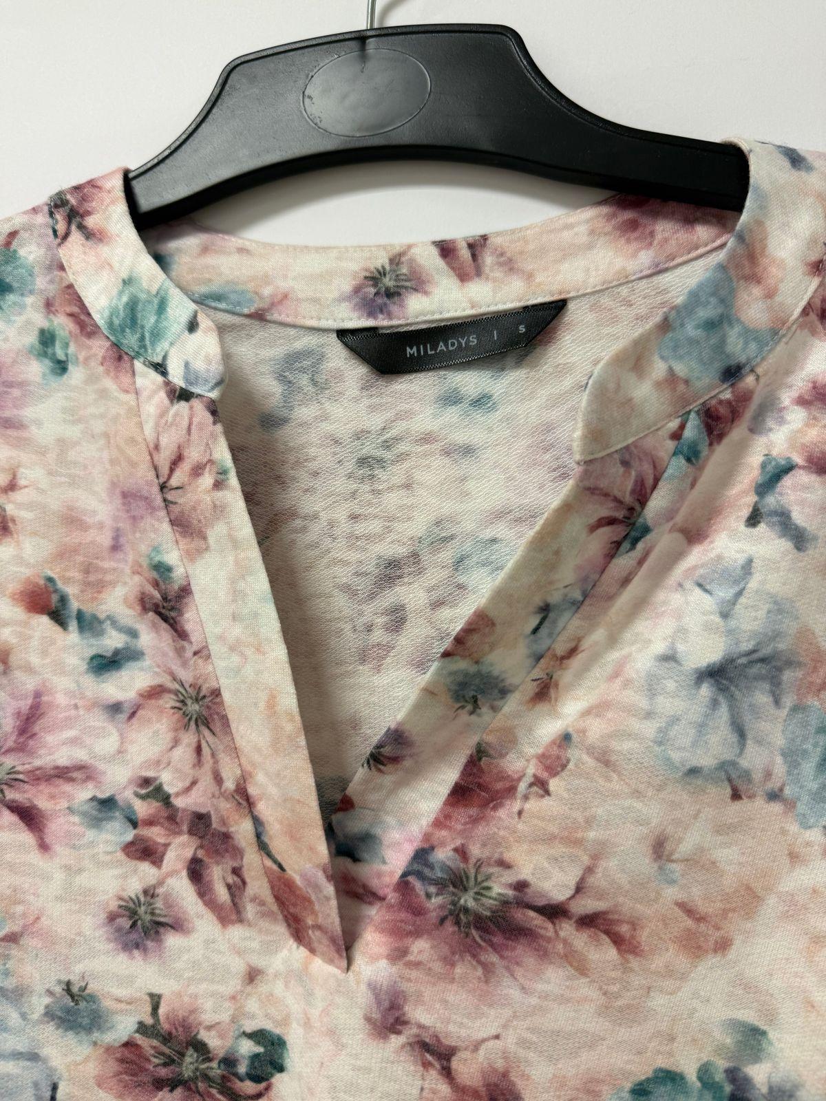 a shirt that has a flower pattern on it