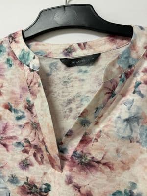 a shirt that has a flower pattern on it